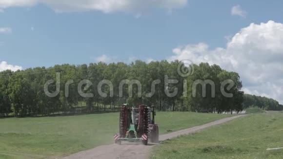 拖拉机在森林附近的耕地上施肥视频的预览图
