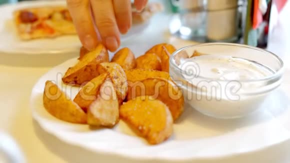 一个女人在咖啡馆里吃着炸土豆和酱汁视频的预览图