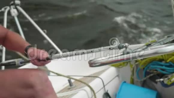白种人的手躺在帆船的舵柄上视频的预览图