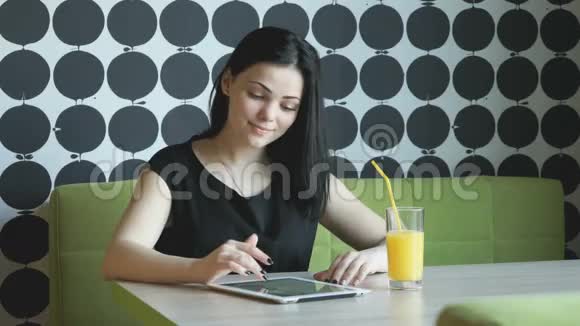 女孩用银色电脑平板电脑看照片视频的预览图