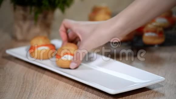 女性的手在白色盘子里放三文鱼视频的预览图