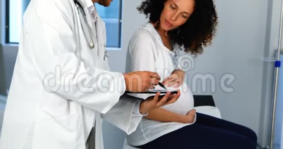 医生向孕妇出示医疗报告视频的预览图
