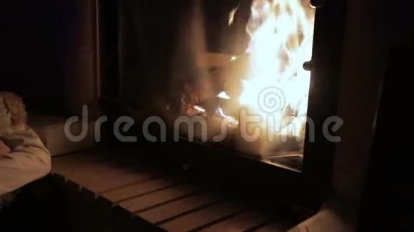 一个悲伤的小女孩坐在壁炉边看着火视频的预览图