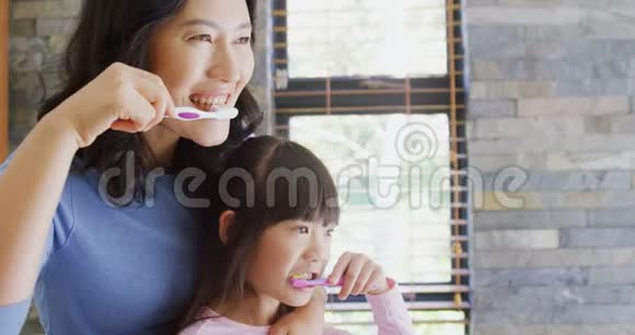 母亲和女儿在浴室刷牙4k视频的预览图