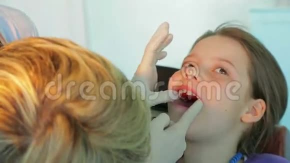 正畸医生在女孩嘴里试牙视频的预览图