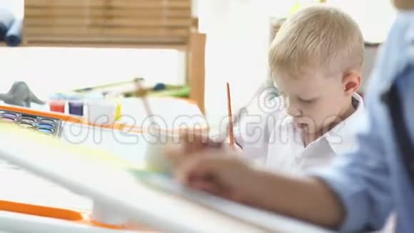 两个男孩努力画画孩子们的友谊视频的预览图