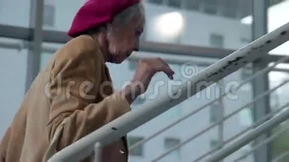 老妇人在公寓楼里爬楼梯视频的预览图