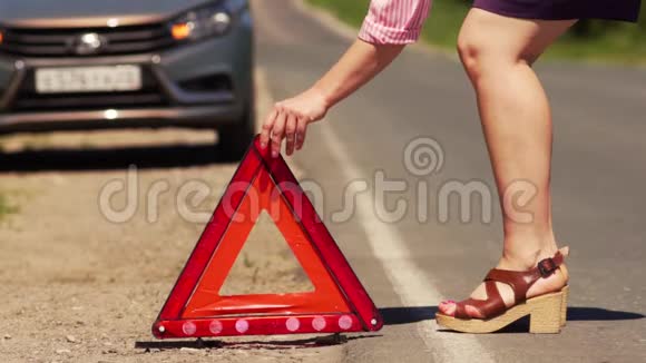 女子在道路上设置红色紧急停车标志视频的预览图