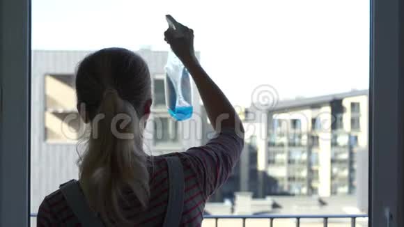 年轻的女人打扫窗户视频的预览图