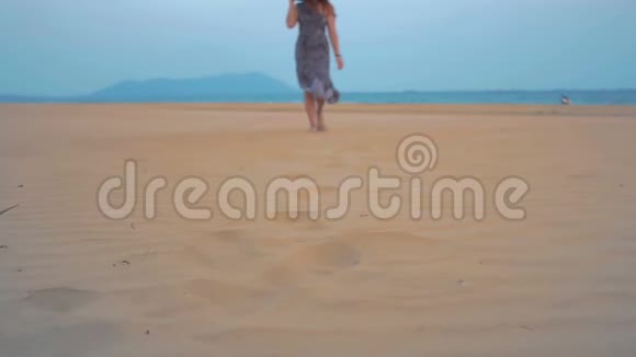 小女孩正沿着海滩散步击中了腿慢动作视频的预览图