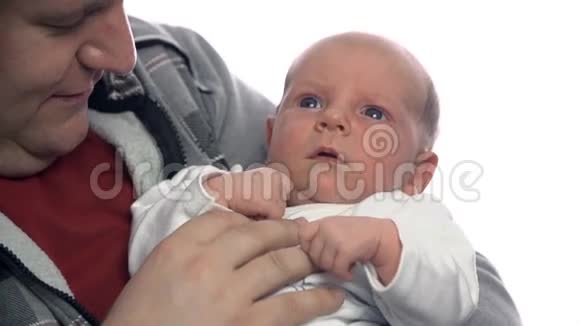 孩子在父亲的怀抱里躺在白色背景下视频的预览图