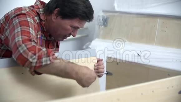 男人用螺丝刀把床架放在一起视频的预览图