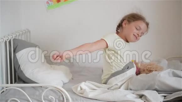 小女孩从睡梦中醒来一个好女孩喜欢阳光明媚的早晨早上好在家视频的预览图