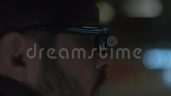 戴眼镜的人晚上坐在车里眼镜里灯光的倒影视频的预览图