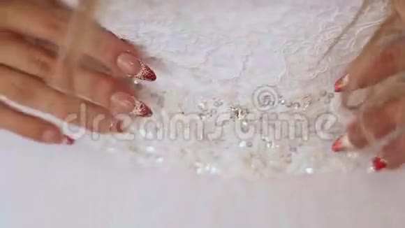 华丽的婚纱和美丽的指甲在新娘的手上视频的预览图