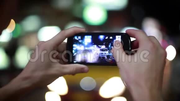 带着手机的游客在夜街用bokeh灯拍照快关门1920x1080高清视频的预览图