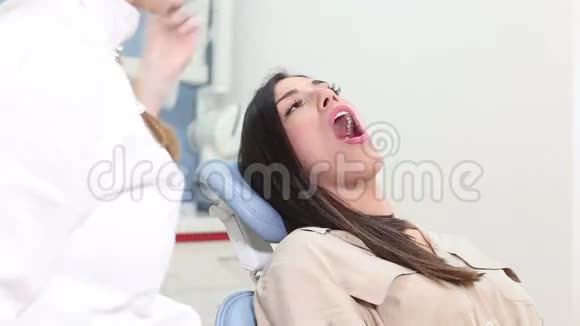 注射止痛剂后坐在牙科椅上的女性病人视频的预览图
