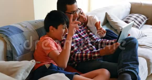 4k客厅的父亲和孩子使用数码平板电脑视频的预览图