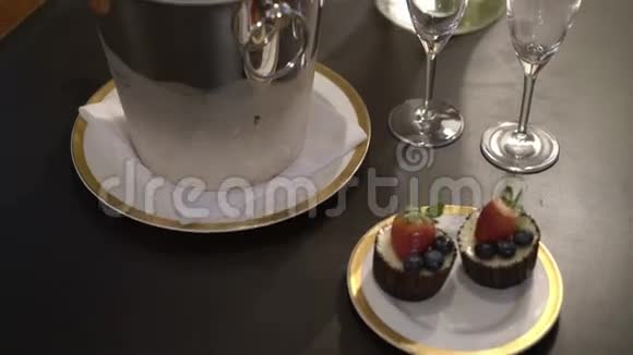 冰桶中的糕点玻璃杯和一瓶香槟视频的预览图