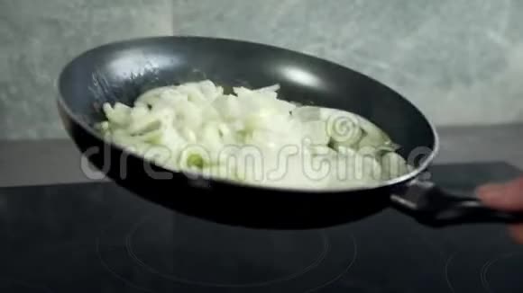 厨师用热煎锅炒洋葱蔬菜煮熟与蔬菜一起食用视频的预览图