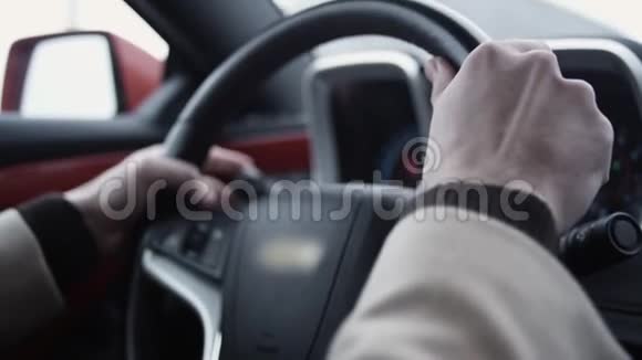 在光明的日子里驾驶昂贵的汽车的人手挽着方向盘视频的预览图