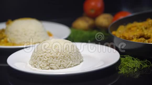 咖喱鸡印度菜蒸饭厨师在蒸饭中加入咖喱鸡放在黑色的盘子里视频的预览图