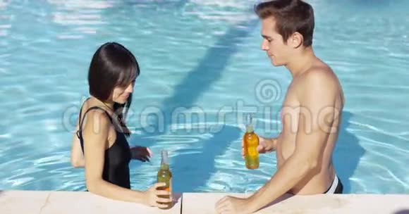 一对英俊的年轻夫妇在游泳池里狂欢视频的预览图