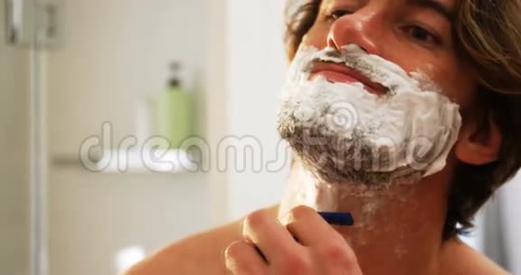 用剃刀刮胡子的人视频的预览图