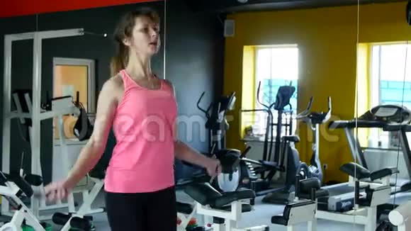年轻的运动女性在健身房里用跳绳和健康的常规健身视频的预览图