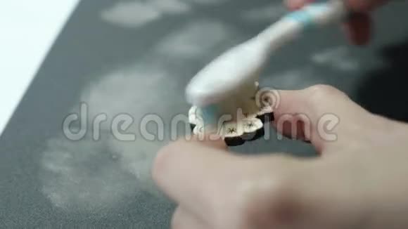 一位艺术家在砂纸上打磨后用刷子把木器擦干净视频的预览图