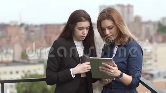 一群商人在平板电脑的屏幕上互相交谈和展示信息旋转抱着一个视频的预览图