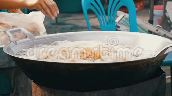 泰国和亚洲的街头食品一个大的煮沸的大桶女人用手烹调并放入鸡块小鸡视频的预览图