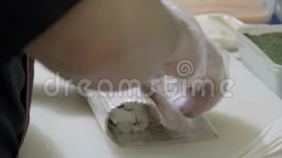 特写做寿司厨师在厨房里准备面包卷搓米饭和诺丽切工件使用日语视频的预览图