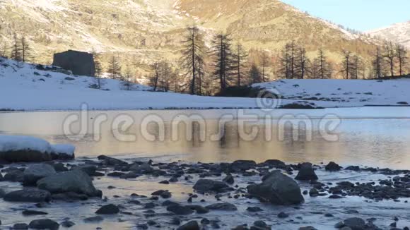冬季河流流向意大利阿尔卑斯山冻结的山湖视频的预览图