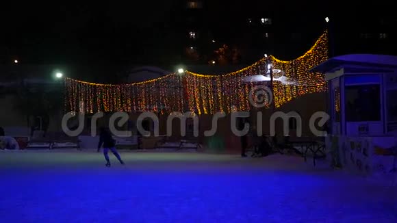 在冬季圣诞公园滑冰的年轻人慢动作视频的预览图