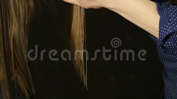 专业的理发师在发廊中将女性客户的头发剪成刘海慢动作视频的预览图