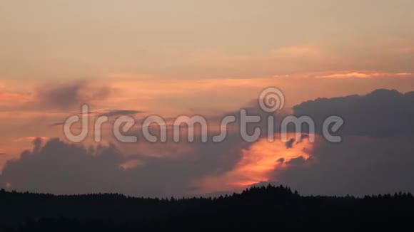 夕阳中的云彩和杉树上的云彩时间流逝视频的预览图