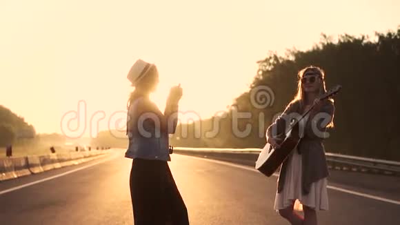 少女潮人在电影摄影机上给女友拍照两名年轻妇女在黎明时被拍照慢动作视频的预览图