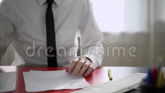 他在办公桌上看文件视频的预览图