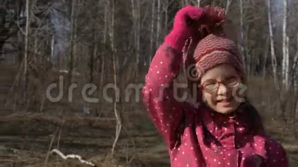 女孩在春天的森林里玩得很开心一个女孩在一片空地上跳舞肖像特写视频的预览图
