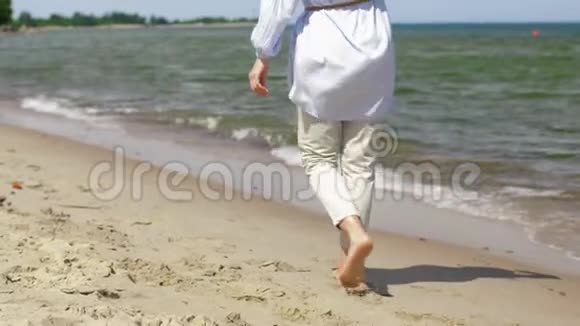 女人光着脚走在海滩上视频的预览图