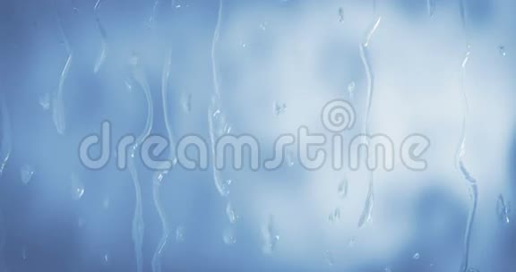 玻璃窗蓝色的水滴特写视频的预览图