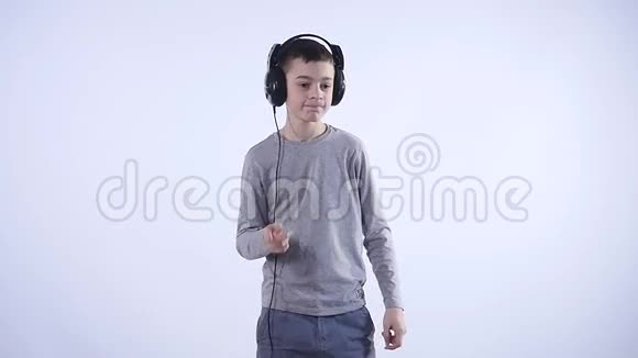 带着耳机的快乐少年被隔离在白色背景上视频的预览图