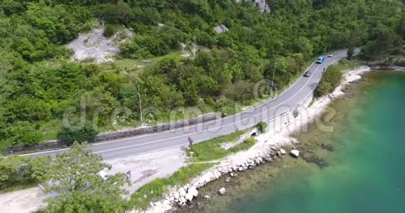 飞越一条沿着海岸行驶的柏油路车辆沿着公路行驶视频的预览图
