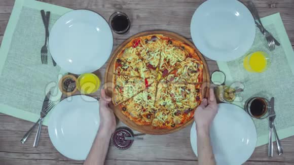 从桌子上的盘子里取出披萨切割的顶部视图视频的预览图