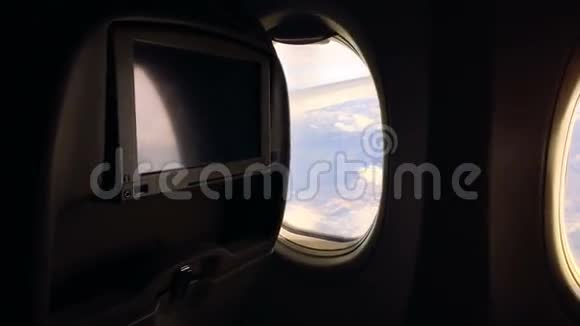 女孩坐飞机飞行欣赏舷窗的风景并关闭它视频的预览图