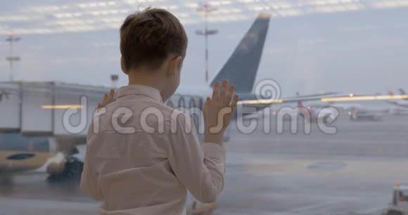 等待飞行的儿童和透过窗户看飞机的儿童视频的预览图