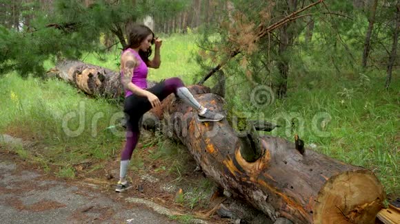 森林里的运动女孩做伸展运动看着相机微笑着视频的预览图