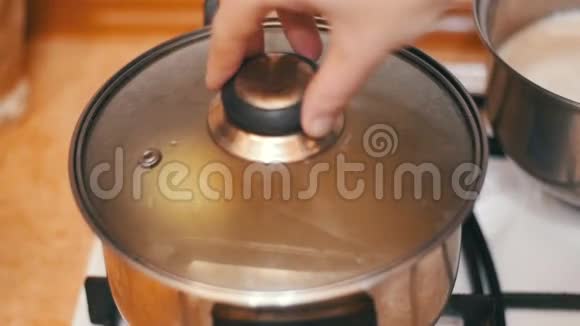 烧水壶中的洋葱是在家庭炉灶上准备的慢动作视频的预览图