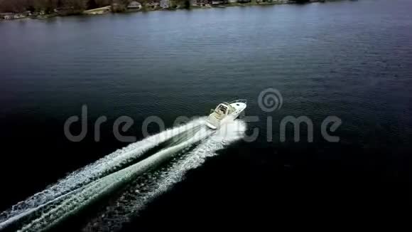 豪华的白色摩托艇游艇在平静的深蓝河水海景中缓缓驶去令人惊叹的4k空中无人机视野视频的预览图
